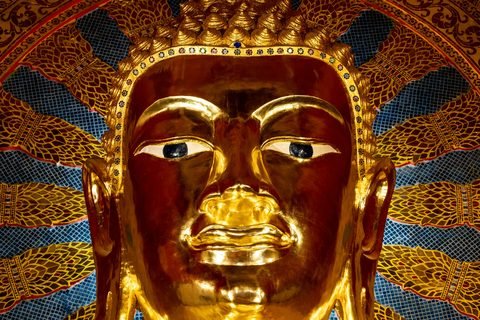 The gilded face of a Buddha image against an inlaid halo