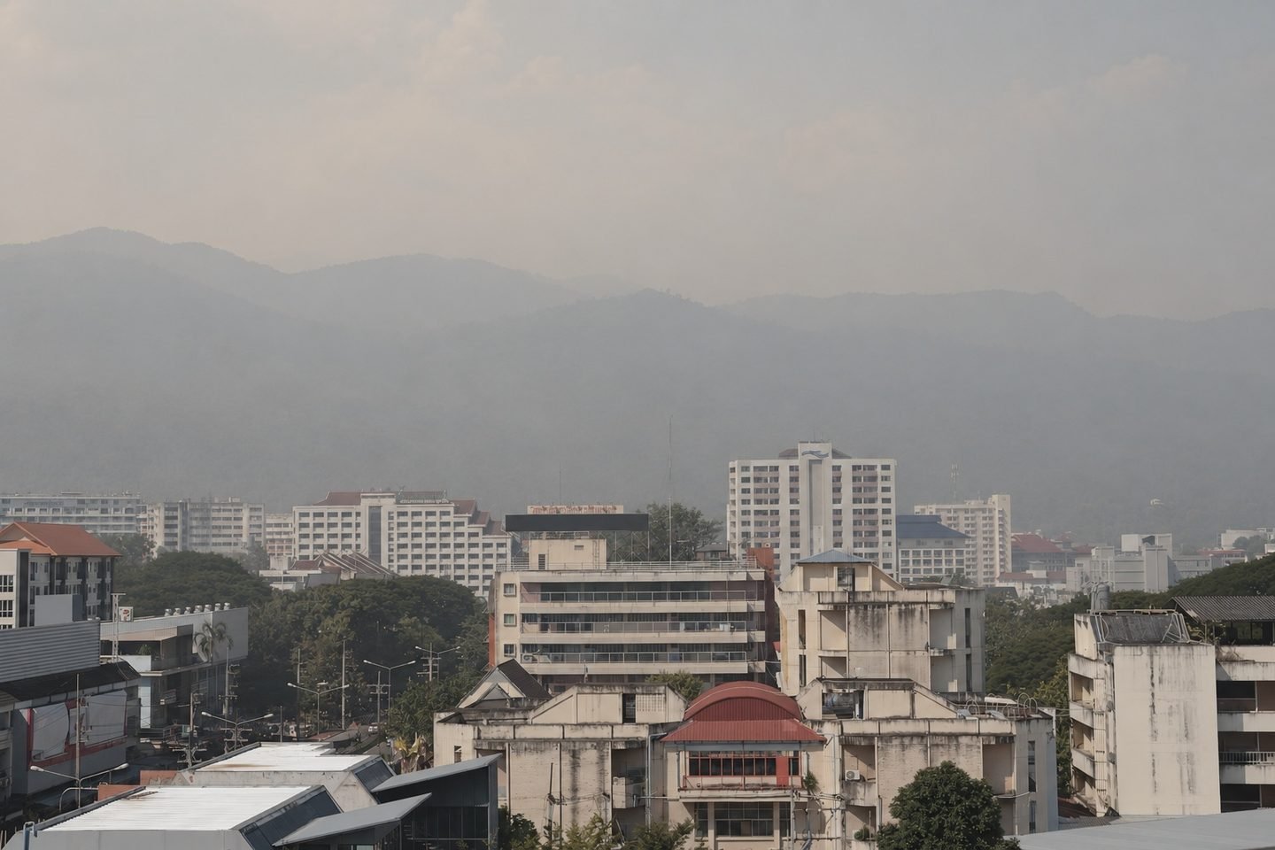 Chiang Mai's buildings and the mountains behind them obscured by smoke