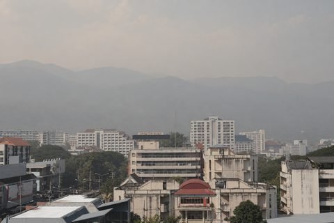 Chiang Mai's buildings and the mountains behind them obscured by smoke