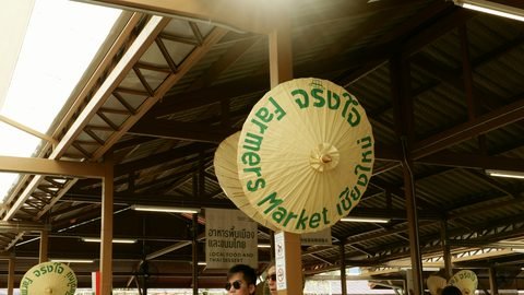 Painted parasols hanging under the roof of the farmers' market hall