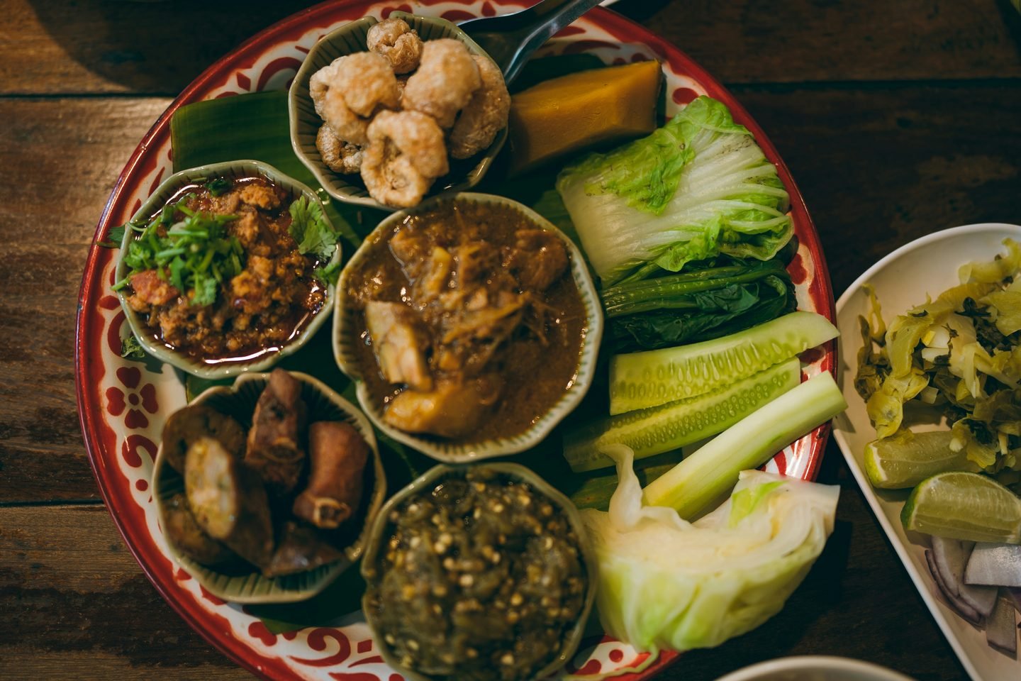 A northern Thai tray of dips, curries and raw vegetables served together