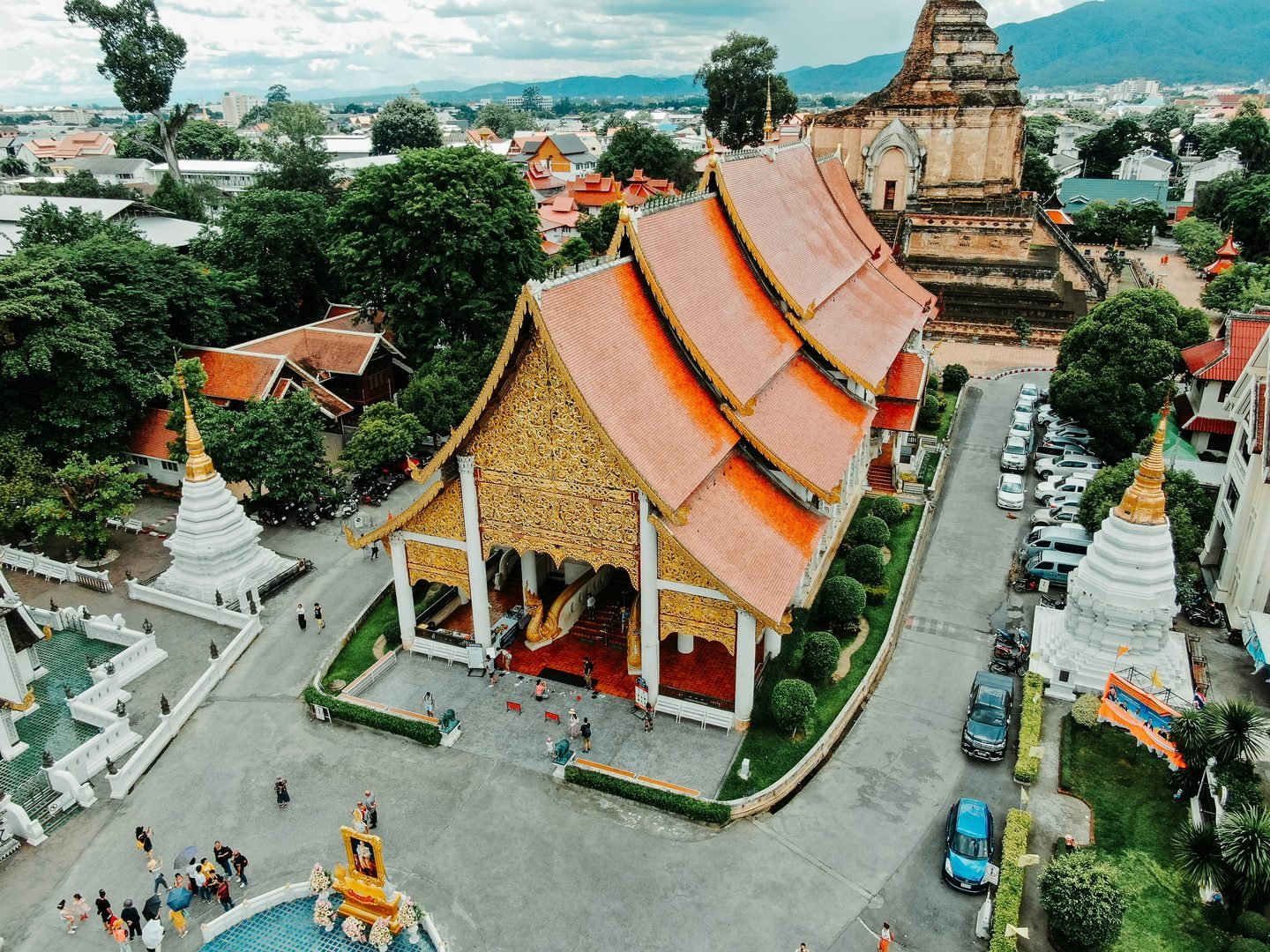 A Lanna temple and its chedis seen from above, in the middle of the city