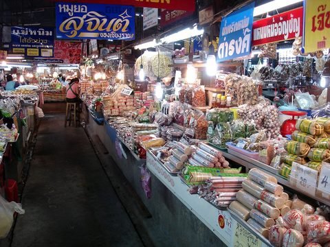 A ground-floor aisle lined with rolls of moo yor, banana-leaf parcels of naem and bags of dried goods