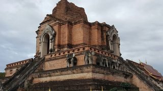 The truncated brick chedi of Wat Chedi Luang, elephants of brick and stucco set into its stepped base